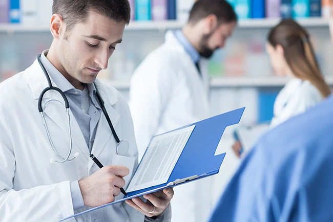 Healthcare provider reviewing credentialing documents and enrollment records as part of the medical credentialing process